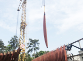 A crane lifts a piece of wood into place during construction of the French embassy in gabon